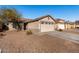 House exterior showcasing a two-car garage and neighborhood view at 574 W Kingman Dr, Casa Grande, AZ 85122