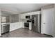 Modern kitchen with white cabinets and stainless steel appliances at 574 W Kingman Dr, Casa Grande, AZ 85122