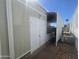 Side exterior view of home with white doors, awning, and well-maintained brick walkway at 8700 E University Dr # 2020, Mesa, AZ 85207