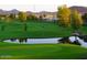 Scenic view of a lush green golf course with a tranquil pond and mature trees, ideal for recreation at 8700 E University Dr # 2020, Mesa, AZ 85207