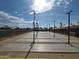 Community shuffleboard courts lined by benches and street lights for social gatherings at 8700 E University Dr # 2020, Mesa, AZ 85207