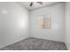 Simple bedroom with carpet flooring, a window, and ceiling fan at 26058 W Yukon Dr, Buckeye, AZ 85396