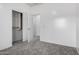 Carpeted bedroom featuring closet and door to another room at 26058 W Yukon Dr, Buckeye, AZ 85396