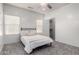 Bright bedroom with a queen bed, carpet, and a closet visible through an open door at 26058 W Yukon Dr, Buckeye, AZ 85396