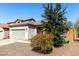 Charming single-story home with a two car garage and desert landscaping at 26058 W Yukon Dr, Buckeye, AZ 85396