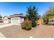 Charming single-story home with a two car garage and desert landscaping at 26058 W Yukon Dr, Buckeye, AZ 85396