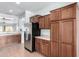 Kitchen boasts ample wood cabinets, stainless steel fridge, and laminate countertops at 26058 W Yukon Dr, Buckeye, AZ 85396