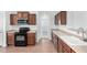 Cozy kitchen featuring wooden cabinetry, laminate countertops, and essential appliances at 26058 W Yukon Dr, Buckeye, AZ 85396