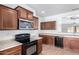 Charming kitchen with wooden cabinets, stainless steel appliances, and a ceiling fan at 26058 W Yukon Dr, Buckeye, AZ 85396