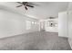 Spacious living room with neutral carpet and an open floor plan at 26058 W Yukon Dr, Buckeye, AZ 85396