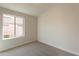 Well-lit bedroom featuring neutral walls and carpet flooring at 3011 E Colonial Pl, Chandler, AZ 85249
