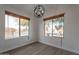 Bright dining area with wood-look flooring and two large windows at 3011 E Colonial Pl, Chandler, AZ 85249
