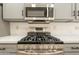 Stainless steel gas range and microwave in updated kitchen at 3011 E Colonial Pl, Chandler, AZ 85249