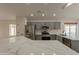 Modern kitchen with gray cabinets, quartz countertops, and stainless steel appliances at 3011 E Colonial Pl, Chandler, AZ 85249
