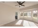 Spacious carpeted bedroom with large window and bathroom access at 3011 E Colonial Pl, Chandler, AZ 85249