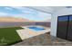 View of a pristine backyard, complete with a refreshing pool, manicured lawn, and stylish patio at 7240 N 13Th Ln, Phoenix, AZ 85021