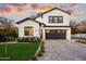 Stunning two-story home with a white exterior, landscaping, and a paved driveway at 7240 N 13Th Ln, Phoenix, AZ 85021
