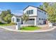 Charming two-story home with a grey driveway, lush landscaping, and modern architectural details at 7240 N 13Th Ln, Phoenix, AZ 85021