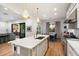Modern kitchen with island, stainless steel appliances, and white cabinetry at 7240 N 13Th Ln, Phoenix, AZ 85021