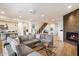 Spacious living room with sectional sofa, fireplace, and kitchen views at 7240 N 13Th Ln, Phoenix, AZ 85021