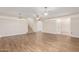 Spacious living area with hardwood floors, staircase, and access to other rooms at 568 N Falcon Dr, Gilbert, AZ 85234
