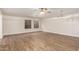 Bright living room with hardwood floors, ceiling fan, and stylish light fixtures at 568 N Falcon Dr, Gilbert, AZ 85234