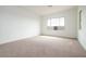 Bright bedroom with carpet flooring, large window, and white walls at 829 W Golden Ore Pass, Apache Junction, AZ 85120