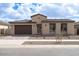 Charming single-story home featuring a tile roof, desert landscaping, and a two-car garage at 829 W Golden Ore Pass, Apache Junction, AZ 85120