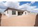 Exterior angle showcasing the home's backyard, desert landscaping, and neutral color palette at 829 W Golden Ore Pass, Apache Junction, AZ 85120