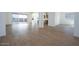 Bright living room with wood-look tile flooring, open layout, and access to outdoor space at 829 W Golden Ore Pass, Apache Junction, AZ 85120