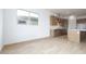Open floor plan with wood-look tile flooring, neutral paint, and large windows at 829 W Golden Ore Pass, Apache Junction, AZ 85120