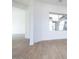 Bright living room with wood-look tile flooring, with an adjacent hallway at 829 W Golden Ore Pass, Apache Junction, AZ 85120