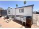 Charming exterior elevation with brick patio and palm trees in the background at 225 S Motherlode Dr, Apache Junction, AZ 85119