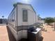 Well-maintained manufactured home with modern siding and energy-efficient air conditioning unit visible at 225 S Motherlode Dr, Apache Junction, AZ 85119