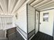 Cozy front porch with table and chairs and access to an exterior laundry closet at 225 S Motherlode Dr, Apache Junction, AZ 85119