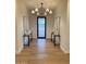 Elegant foyer featuring a modern chandelier and stylish console tables at 25219 S 194Th St, Queen Creek, AZ 85142