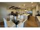 Open-concept living area with a kitchen, dining area, and a cozy living room featuring wood beams and hardwood floors at 25219 S 194Th St, Queen Creek, AZ 85142