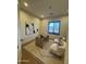 Stylish home office featuring a desk, seating, geometric rug, modern art, and natural light from the window at 25219 S 194Th St, Queen Creek, AZ 85142