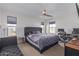 Spacious bedroom with king-size bed, desk and seating area at 3714 S 58 Dr, Phoenix, AZ 85043