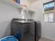 Laundry room with washer, dryer and shelving at 3714 S 58 Dr, Phoenix, AZ 85043