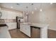 Modern kitchen featuring white cabinets, quartz countertops, and stainless steel appliances at 17862 W Blue Sky Dr, Surprise, AZ 85387