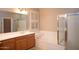 Bright bathroom features a soaking tub and a glass-enclosed shower at 2116 N 81St Cir, Mesa, AZ 85207