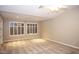 Spacious bedroom with plantation shutters, neutral color palette, and carpet flooring at 2116 N 81St Cir, Mesa, AZ 85207