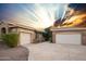 Charming home featuring a stone and stucco facade, with a large driveway and well-maintained landscaping at 2116 N 81St Cir, Mesa, AZ 85207