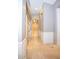 Hallway with white wainscoting, travertine floors, and views of adjoining rooms at 2116 N 81St Cir, Mesa, AZ 85207