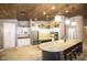 Bright kitchen featuring custom cabinets, stainless appliances, stone accents, and a large island with seating at 2116 N 81St Cir, Mesa, AZ 85207