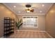 Well-lit room with neutral walls, plush carpeting, and a large window at 2116 N 81St Cir, Mesa, AZ 85207