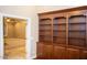 Spacious room with built-in shelving and an open doorway leading to another living area at 2116 N 81St Cir, Mesa, AZ 85207