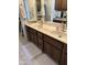Bathroom vanity featuring double sinks, granite countertops, and dark wood cabinetry at 402 W Grandview Rd, Phoenix, AZ 85023