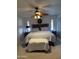 Relaxing bedroom featuring a large bed, ceiling fan, and soft lighting at 402 W Grandview Rd, Phoenix, AZ 85023